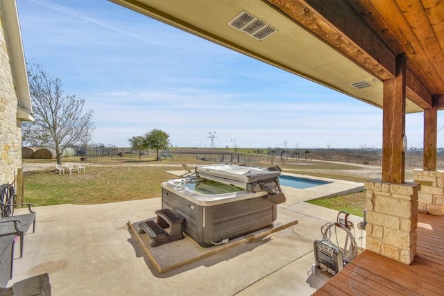 view of patio / terrace featuring an outdoor pool and visible vents