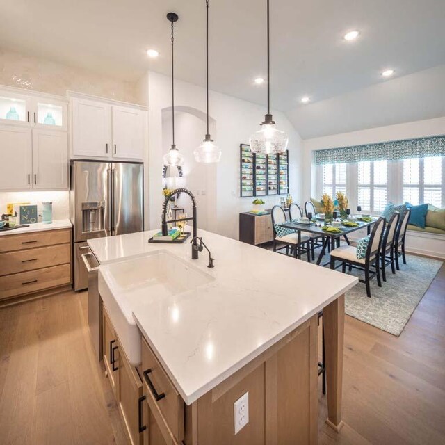 kitchen featuring decorative light fixtures, white cabinetry, recessed lighting, light wood-style floors, and stainless steel fridge with ice dispenser