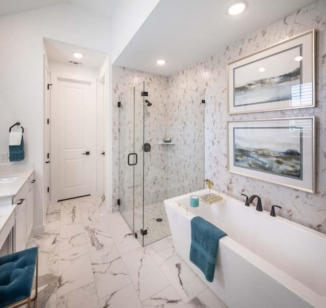 full bath with a freestanding tub, marble finish floor, recessed lighting, a marble finish shower, and vaulted ceiling