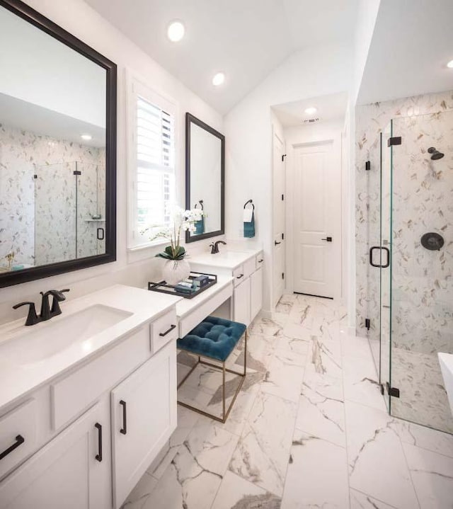 bathroom featuring a marble finish shower, lofted ceiling, marble finish floor, and vanity