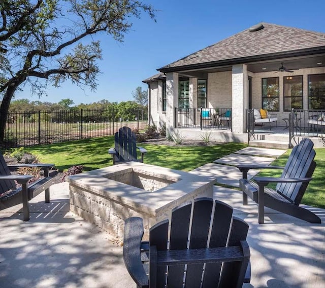 view of patio / terrace featuring a fire pit and fence