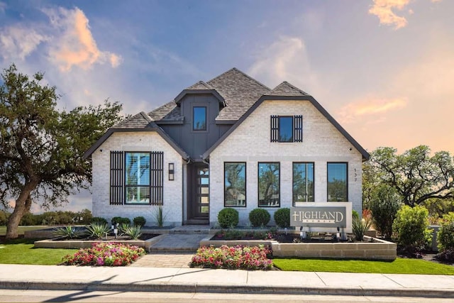 french country inspired facade with roof with shingles