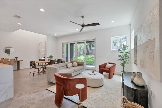 living room featuring ceiling fan, recessed lighting, finished concrete floors, and baseboards