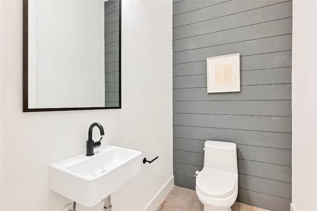 3100 S 5th St Unit 1, Austin, TX 78704 - half bath with a sink, toilet, baseboards, and wood walls