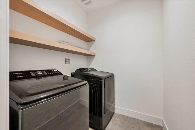 washroom with washer and dryer, visible vents, baseboards, and laundry area