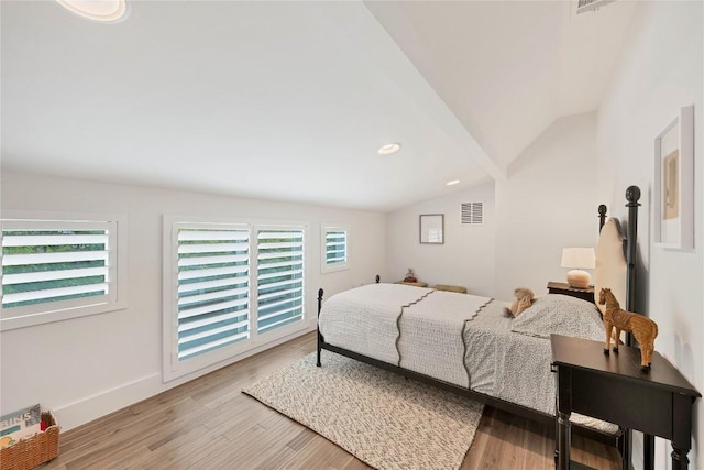 bedroom with baseboards, visible vents, light wood-style flooring, recessed lighting, and vaulted ceiling