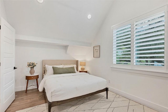 bedroom featuring recessed lighting, light wood-type flooring, baseboards, and vaulted ceiling