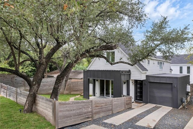 3100 S 5th St Unit 1, Austin, TX 78704 - view of front facade with driveway and a garage
