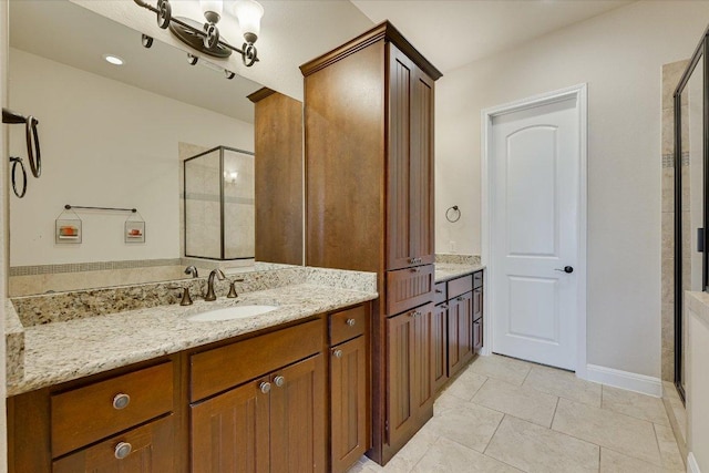 bathroom featuring tile patterned flooring, a shower stall, and vanity