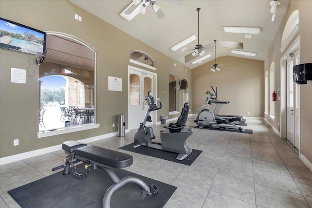 workout room featuring tile patterned floors, baseboards, arched walkways, and high vaulted ceiling