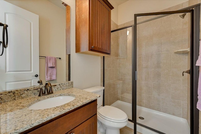 full bath with toilet, a stall shower, and vanity