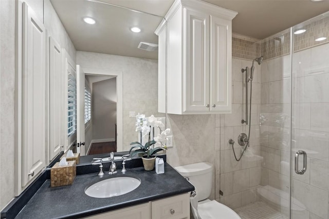 bathroom with visible vents, toilet, recessed lighting, a stall shower, and vanity