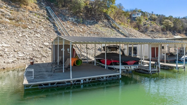 view of dock featuring boat lift and a water view