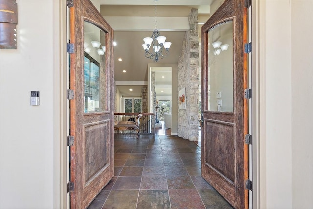 entrance foyer with recessed lighting, an inviting chandelier, and stone tile flooring