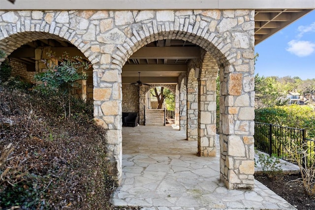 entrance to property with stone siding and a fireplace