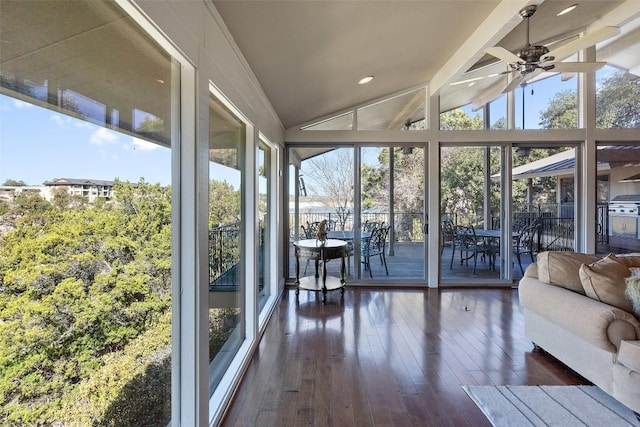 unfurnished sunroom with vaulted ceiling with beams and a ceiling fan