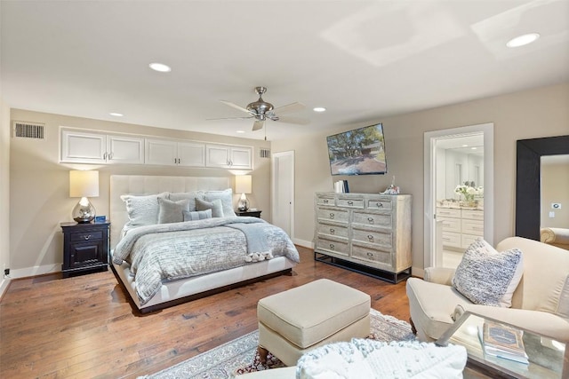 bedroom featuring recessed lighting, wood finished floors, baseboards, and ensuite bathroom