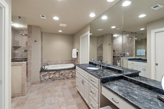 bathroom with vanity, a garden tub, visible vents, and a stall shower