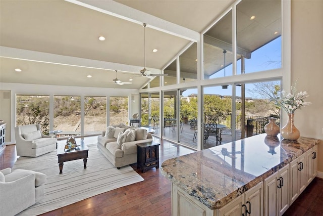 living area with recessed lighting, high vaulted ceiling, and dark wood-style flooring