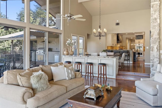 living room with plenty of natural light, wood finished floors, and visible vents