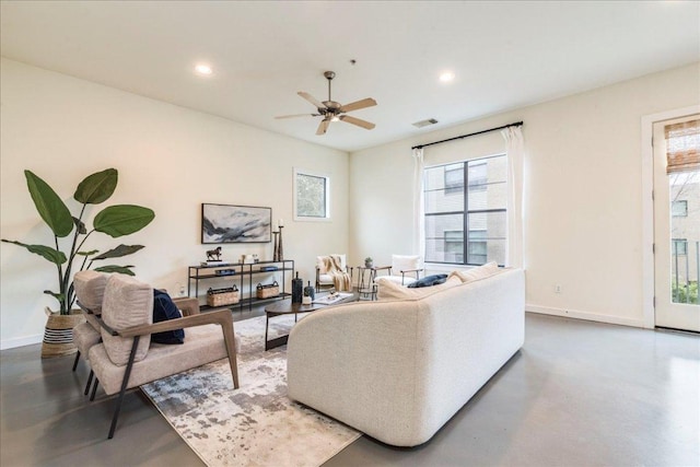 living area with recessed lighting, baseboards, and finished concrete floors