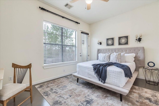 bedroom featuring a ceiling fan, wood finished floors, baseboards, and visible vents