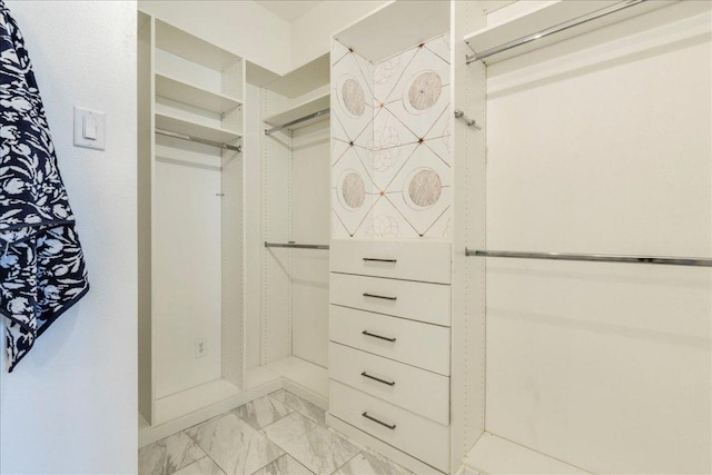 spacious closet featuring marble finish floor