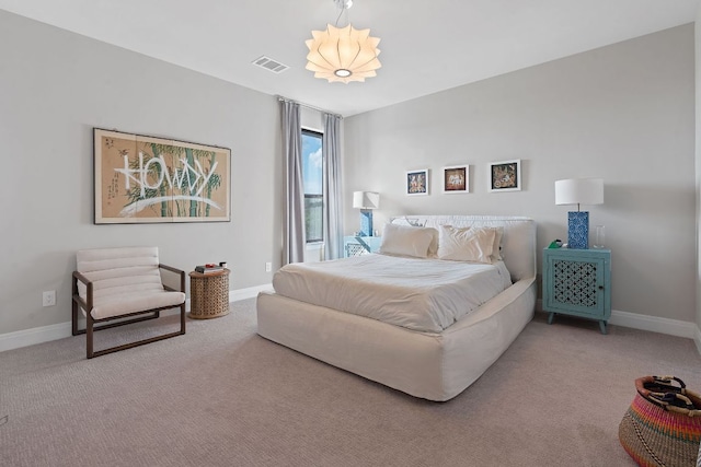 bedroom with carpet, visible vents, and baseboards