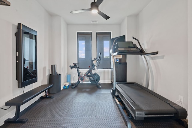 workout area with visible vents, baseboards, and ceiling fan