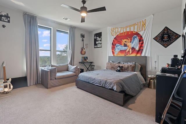 bedroom with visible vents, carpet flooring, and a ceiling fan