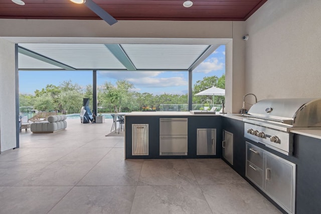 view of patio / terrace with ceiling fan, area for grilling, and a lanai