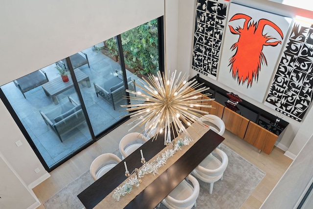 dining area with a notable chandelier and baseboards