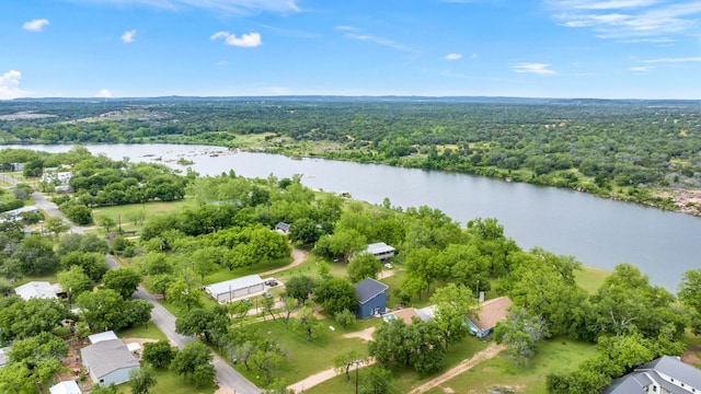 drone / aerial view with a water view and a wooded view