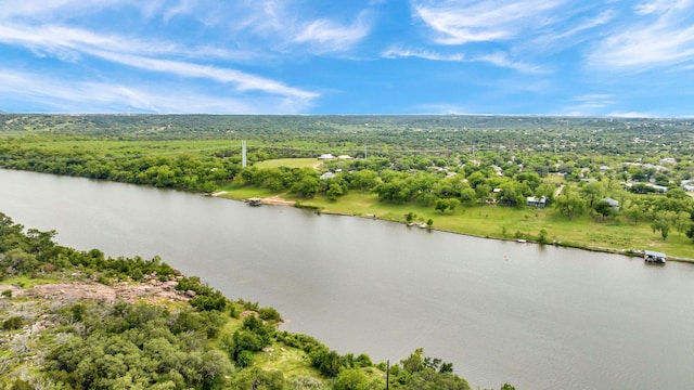 aerial view featuring a wooded view and a water view