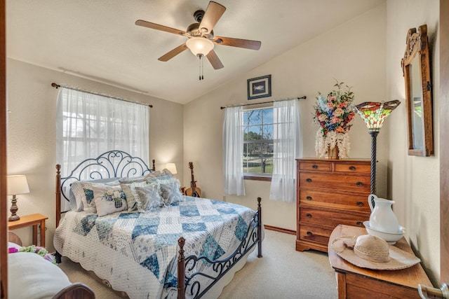 bedroom featuring light colored carpet, a ceiling fan, and vaulted ceiling