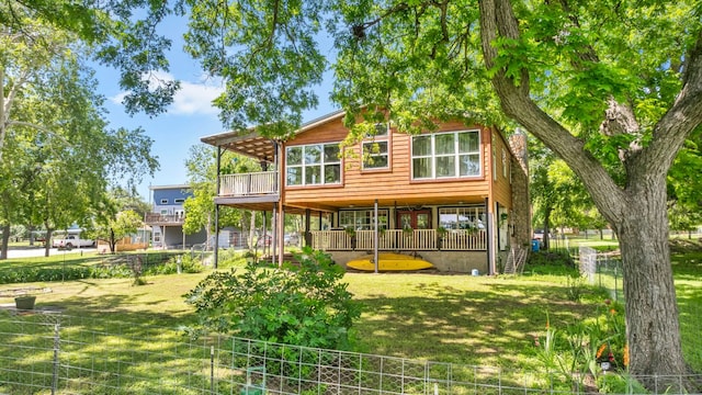 back of house with a lawn and fence