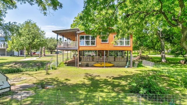 view of play area featuring a yard, a deck, and fence