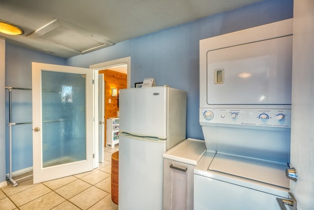 331 Grandview Dr, Horseshoe Bay, TX 78657 - laundry room featuring attic access, estacked washer and dryer, and light tile patterned floors