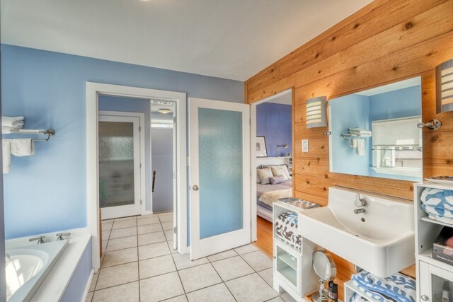 331 Grandview Dr, Horseshoe Bay, TX 78657 - ensuite bathroom featuring wooden walls, a garden tub, and tile patterned floors