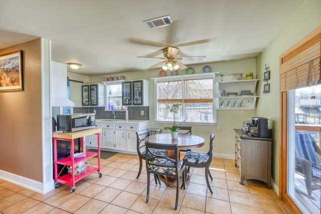 331 Grandview Dr, Horseshoe Bay, TX 78657 - dining area featuring light tile patterned floors, healthy amount of natural light, baseboards, and ceiling fan