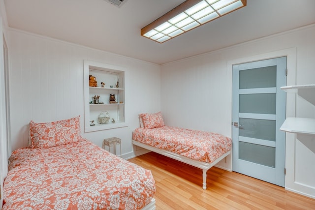 331 Grandview Dr, Horseshoe Bay, TX 78657 - bedroom featuring wood finished floors and crown molding