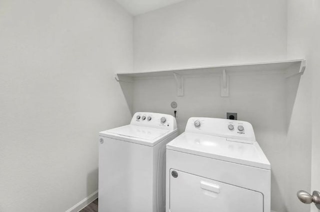 laundry room featuring laundry area, washing machine and dryer, and baseboards