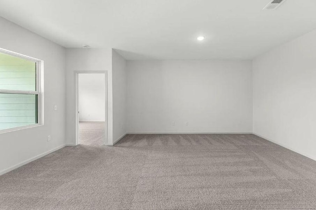 carpeted spare room with recessed lighting, visible vents, and baseboards