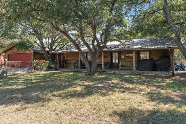 view of front of house with a front lawn and fence