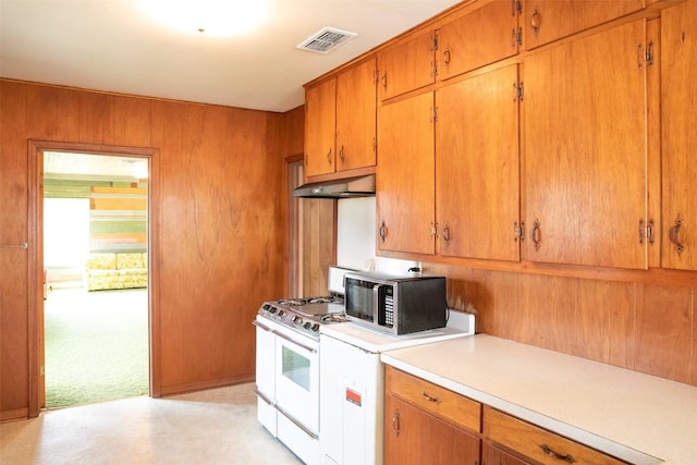 kitchen with visible vents, light countertops, white gas range oven, under cabinet range hood, and stainless steel microwave