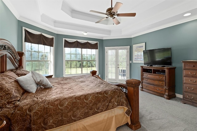 carpeted bedroom featuring a tray ceiling, a ceiling fan, access to exterior, and crown molding