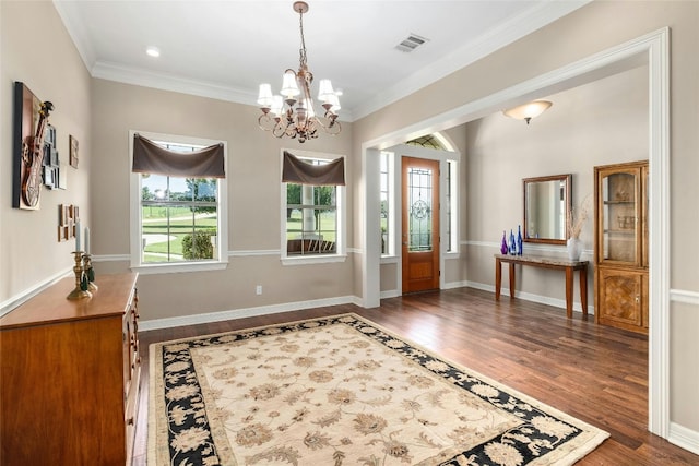 entryway featuring visible vents, crown molding, baseboards, and wood finished floors