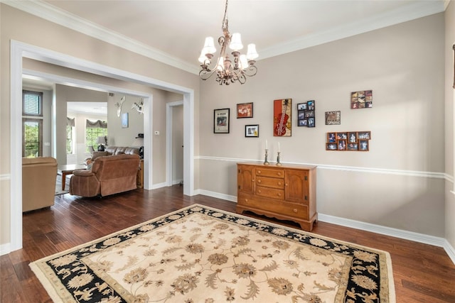 interior space featuring an inviting chandelier, crown molding, dark wood-type flooring, and baseboards