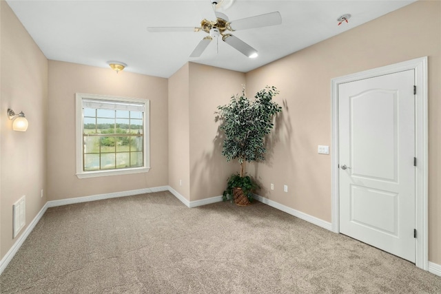 empty room featuring visible vents, baseboards, carpet, and ceiling fan