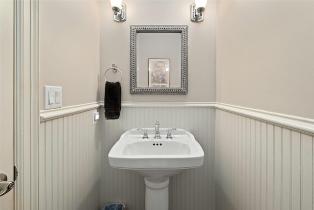 bathroom featuring a sink and a wainscoted wall